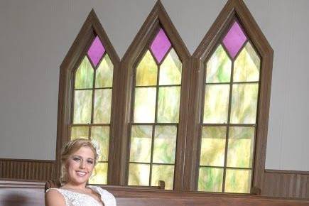 Bride sitting on the pew