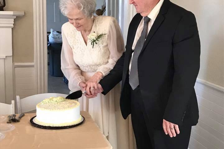 Couple slicing a cakeThe