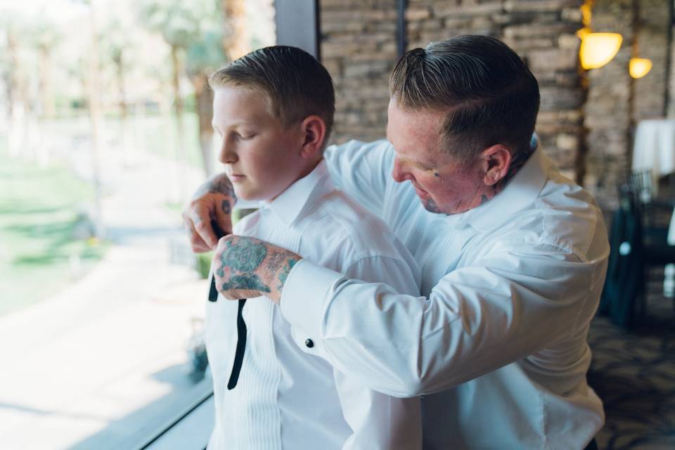 Father tying sons bowtie