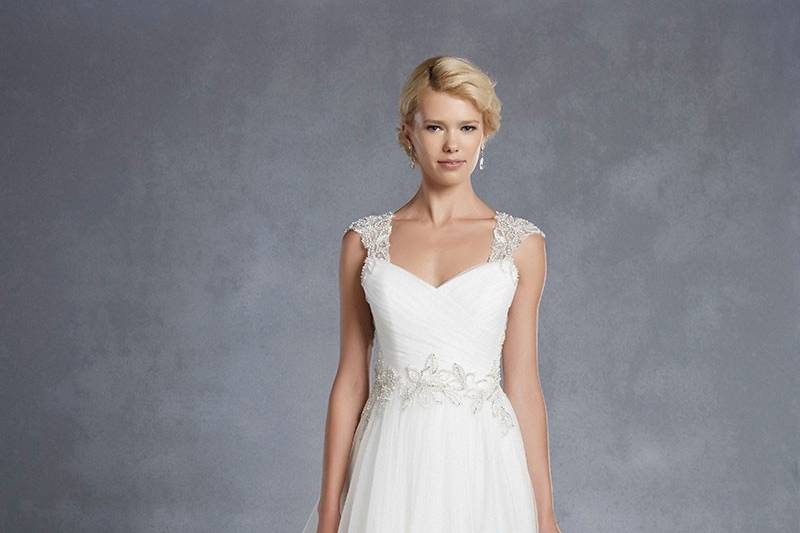 Blue by Enzoani
<br>Halifax
<br>Picture-perfect romance and femininity are epitomized in this tulle A-line gown complete with a soft sweetheart neckline, ruched tulle bodice, and beaded appliqués accentuating the waist. Beaded cap sleeves and a keyhole back provide the ultimate touches of elegance.