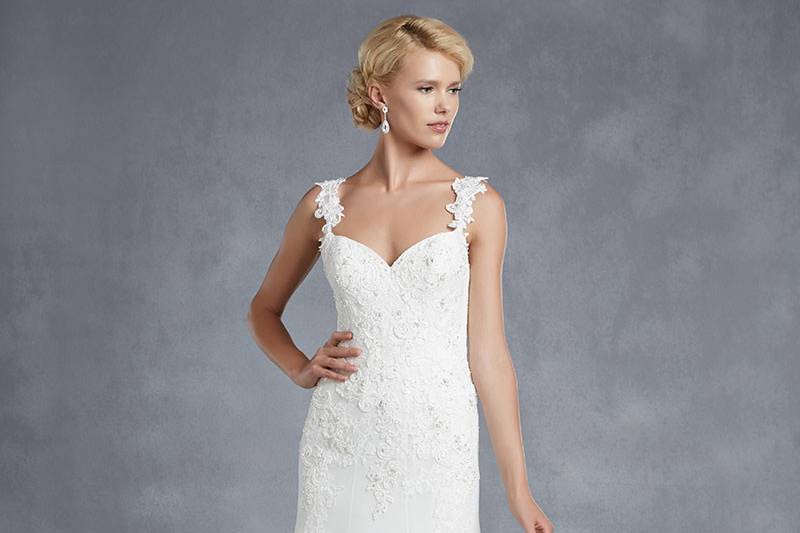 Blue by Enzoani
<br>Henderson
<br>An ultra-romantic sweetheart neckline, beautiful floral embroideries on the bodice, and floral appliqué-accented straps form a picture-perfect bridal look in this modified A-line gown. Sequined hem lace, a low back, and invisible zipper provide the loveliest final touches.