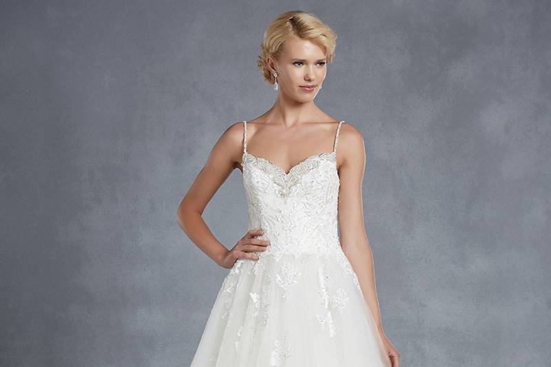 Blue by Enzoani
<br>Highland
<br>Fairy-tale romance and elegance are embodied in this full tulle A-line gown with a beading-accented sweetheart neckline and thin beaded straps. A gorgeous bodice featuring beaded appliqués complements the low beaded illusion back with button closures and invisible zipper.