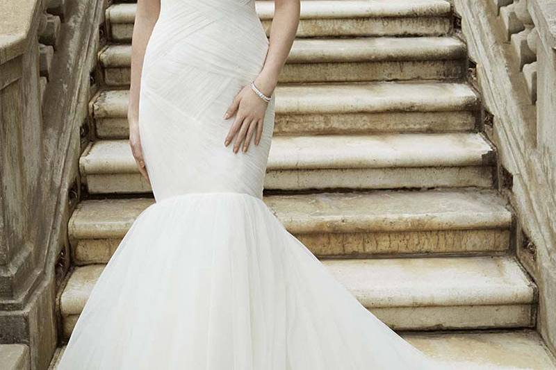 Style Ivalo <br> Full-length mermaid gown with asymmetrical ruched tulle bodice and beaded cap sleeves. Romantic sweetheart neckline and soft tulle layers in the skirt are just as breathtaking as the low keyhole back.