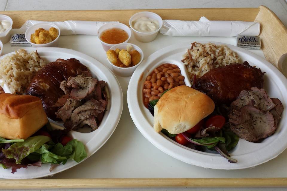 Tri-tip, Teriyaki Chicken, Rice Pilaf, Baked Beans, Spring Salad and Dinner Rolls.  Saucers filled with two separate salad dressings and croutons.