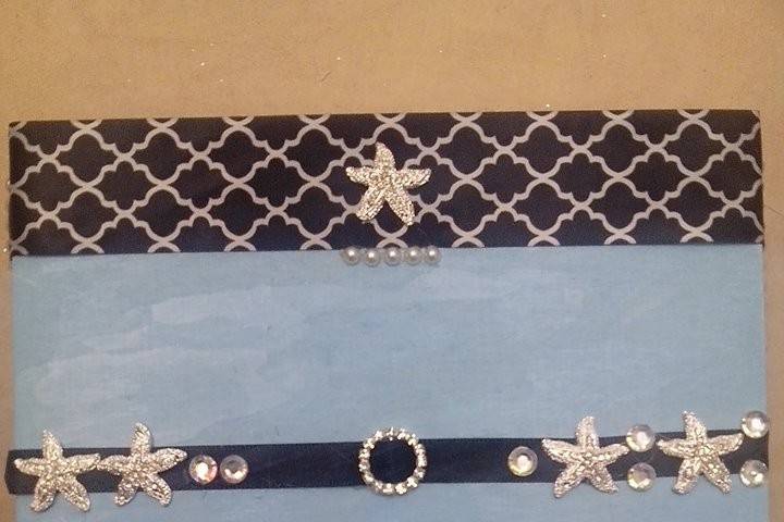 Blue keepsake box, with classic black and white patterned ribbon and diamond broaches