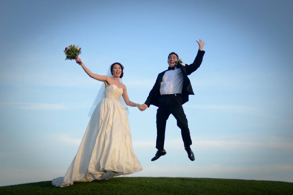 A Magic Moment photographs this couple jumping for joy following their ceremony at Falcon's Fire Golf Club