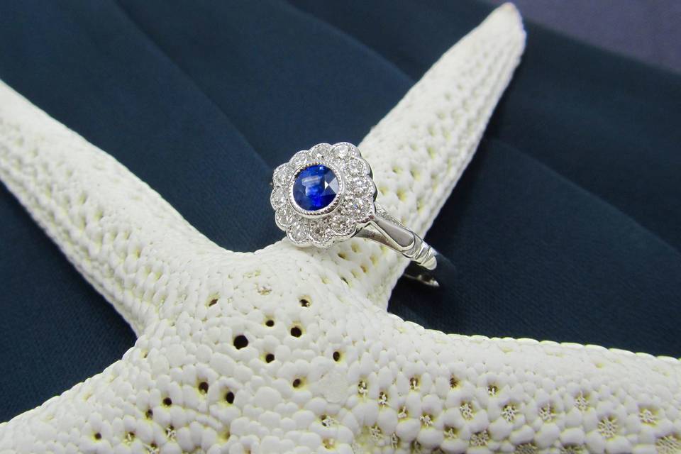 Sapphire and diamond 18 karat white gold cluster style engagement ring.