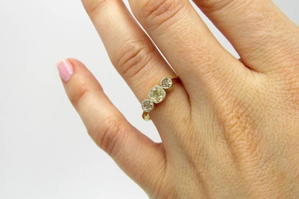 Champagne and yellow diamond vintage three stone engagement ring.