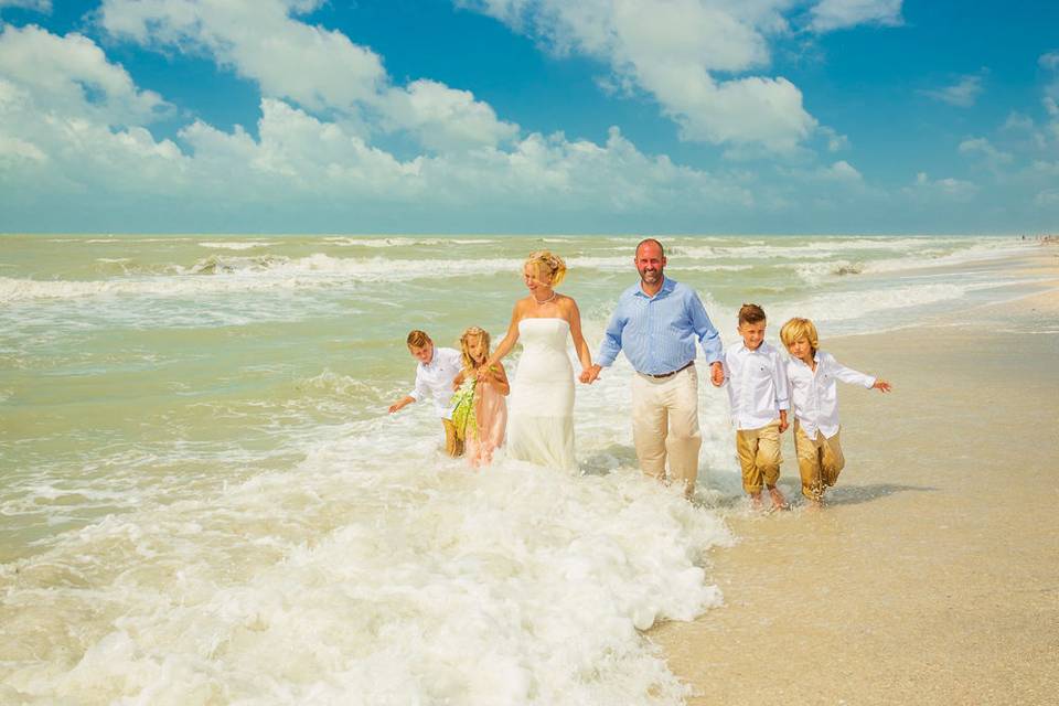 Family running by the shore