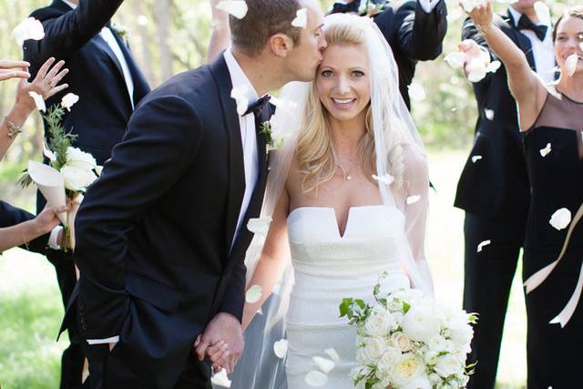 Elegant white wedding | bride & groom at Gardener Ranch, Carmel Valley | Bridal party showering couple with rose petals | Buena Lane Wedding Photography