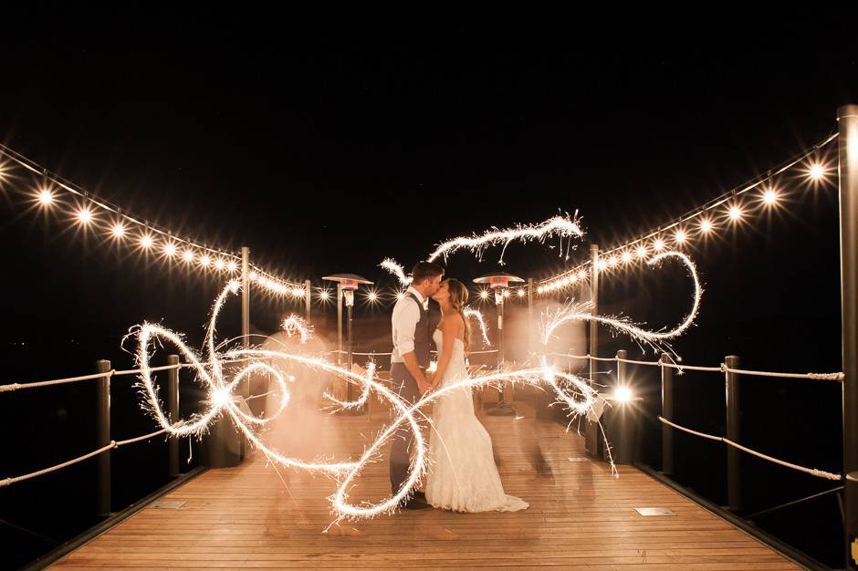 Sparkling end to the night | bride and groom on the dock at West Shore Cafe Lake Tahoe | Buena Lane Wedding Photography