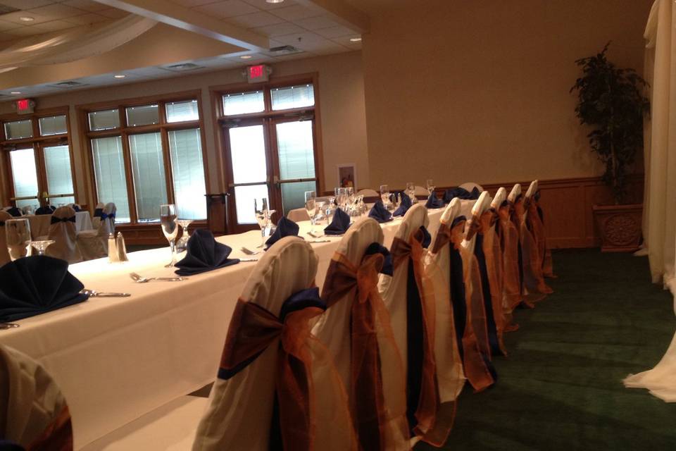 Blue satin and Orange Sheer Sash on White Chair Cover at Stone Ridge Golf Club Bowling Green. Double Sash Bow Tie www.NewChairDo.com