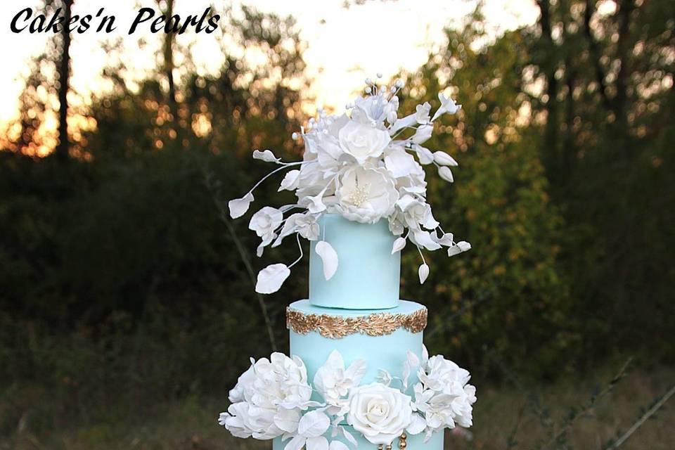 Elegant baby blue cake with white flower decorations