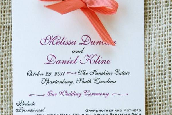 A modern and rustic wedding program with a pretty bow.