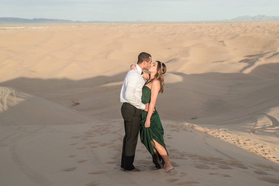 Couple kissing in a desert