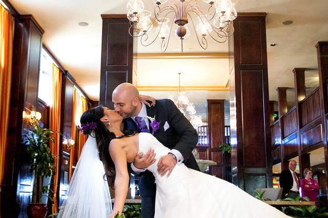 Groom dips his bride for a kiss