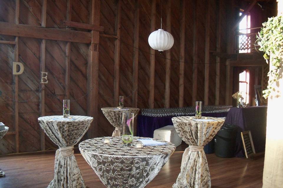 Cocktail tables with linens by abc rentals by cort. Rustic barn wedding on whidbey island with whidbey party girls!