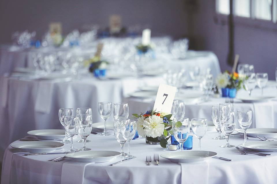 Feather and florals on head table chairs