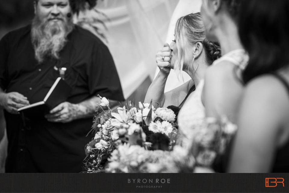 Ceremony arbor draped in farbic and florals