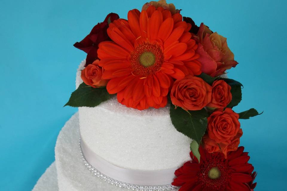 Red flowers cascading the cake