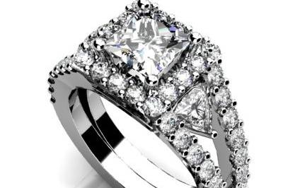 Custom white gold or platinum diamond engagement ring.  Diamond halo with split shank and trillion cut diamonds between.