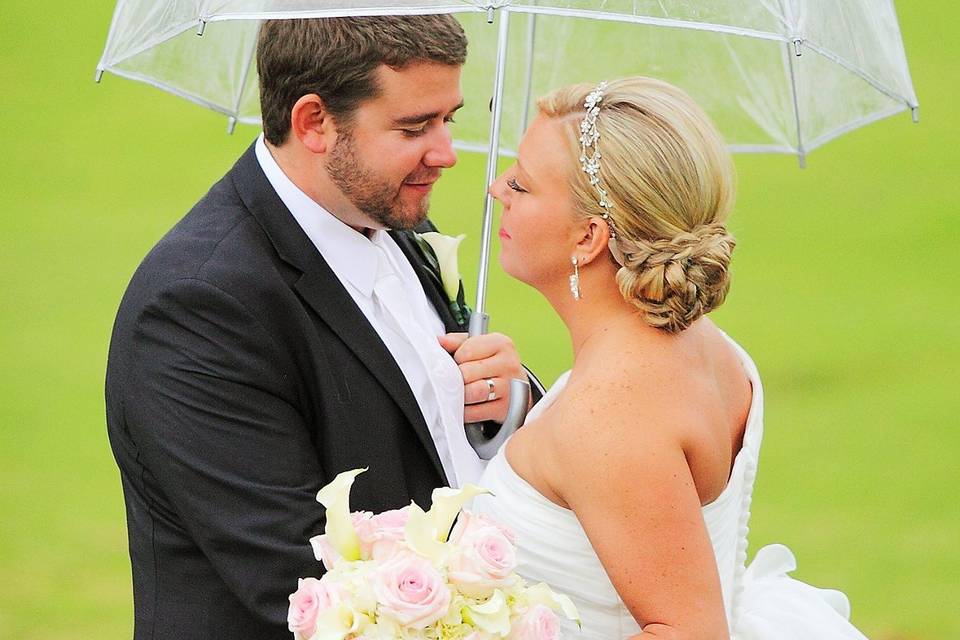 Kiss underneath bride's veil