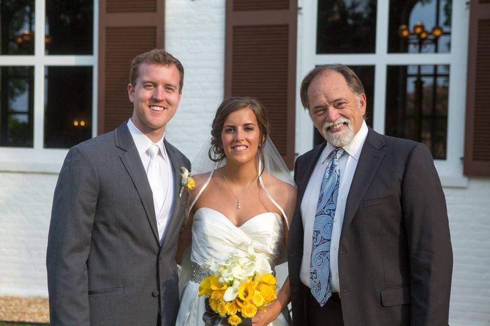 Bride and groom with the officiant