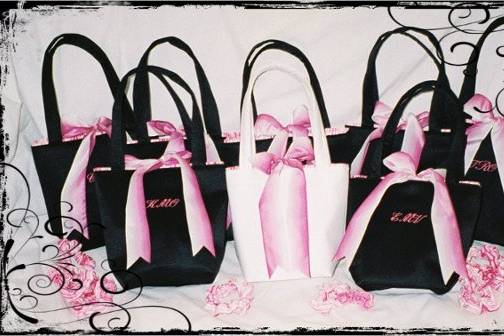 SMALL SQUARE MINI BAG-approx. 7 x 7 x 3.  Bridesmaids shown here in black matte satin, with hot pink & white striped lining, and hot pink to white ombre ribbon bow. Embroidery in hot pink.
Brides bag is white matte satin with hot pink & white striped lining with hot pink to white ombre ribbon.  Embroidery in hot pink.