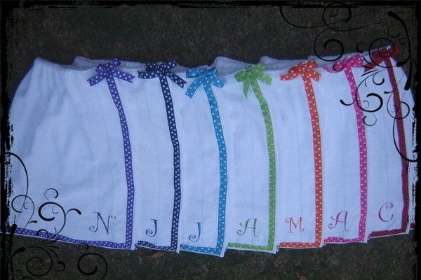 TERRY SHOWER WRAPS-shown here in white, with assorted polkadot ribbon and matching embroidery:)  Embroidery is CURLZ font.
(left to right) purple, navy, turquoise, sage, orange, hot pink and ladybug (red with black)