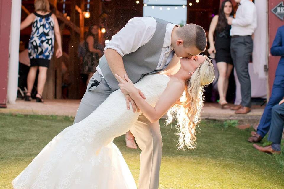 Groom dips his bride for a kiss