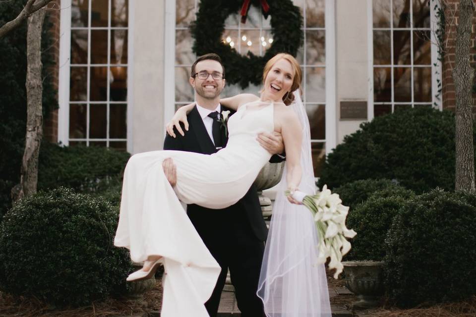 Groom holding bride