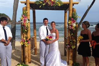 Bride and groom under the beautifully decorated arch at Bolongo Bay, St. Thomas.
