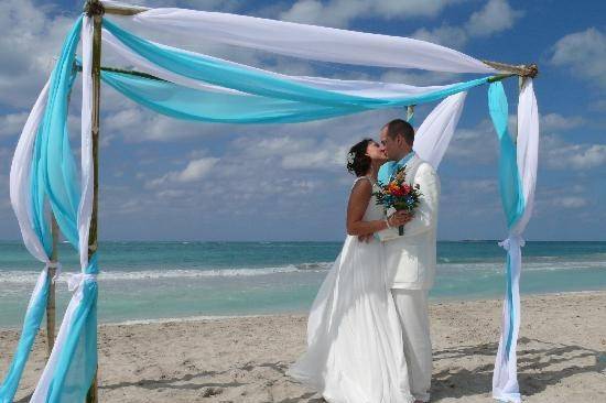 Romantic bamboo arch with turquoise and white drapery for Virgin Islands wedding.