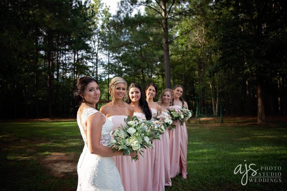 Bride and bridesmaids by the woods