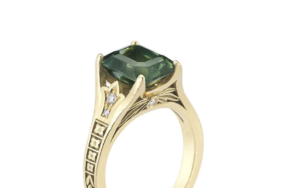 Gorgeous green sapphire in an 18k yellow vintage inspired setting.