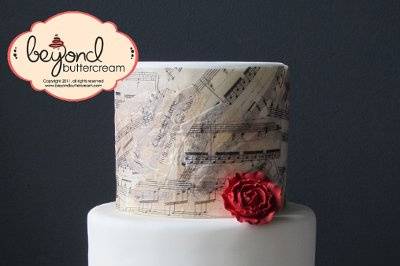 Clair de Lune: Fondant covered cake with the actual sheet music for Clair de Lune printed on with rice paper with edible ink, then put on the cake in a decoupage. Red sugarpaste roses.