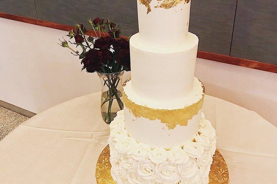 Tall wedding cake with a touch of gold
