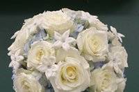 White roses, light blue delphinium, and stephanotis bouquet