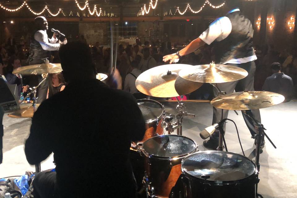 Behind the drums