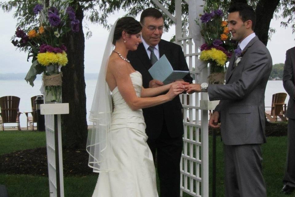 Bride putting the ring on her groom