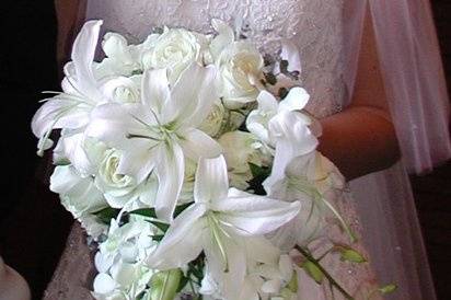 Lilies, orchids and roses in a cascade bouquet