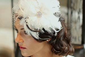 The Fleur is an amazing Flower built with soft hackle feathers topped with silk and marabou petal flower and bobble center. The Fleur comes with the French netting Wedge veil. Available for customizing in the French netting and Set Design areas.