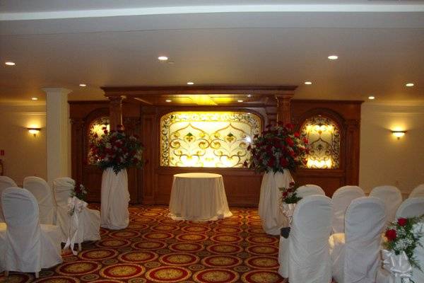 Wedding ceremony flowers designed in red roses at The Merion by Stein Your Florist Co.