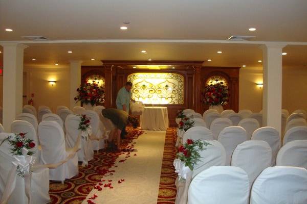 Wedding ceremony flowers designed in red roses at The Merion by Stein Your Florist Co.