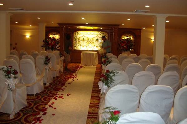 Wedding ceremony flowers designed in red roses at The Merion by Stein Your Florist Co.