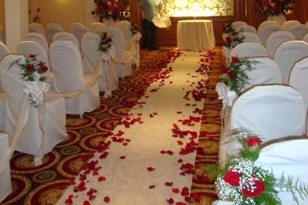 Wedding ceremony flowers designed in red roses at The Merion by Stein Your Florist Co.