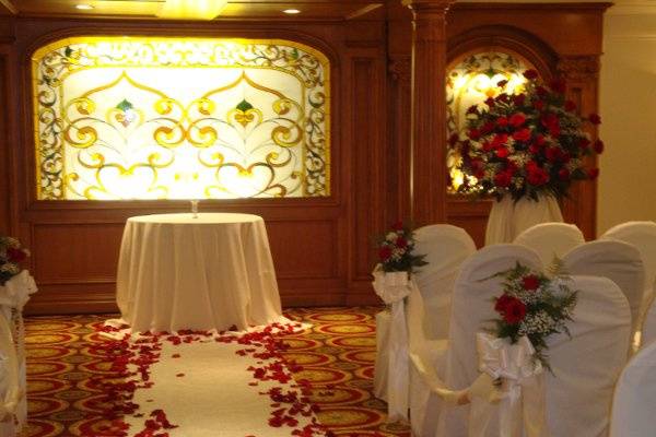 Wedding ceremony flowers designed in red roses at The Merion by Stein Your Florist Co.