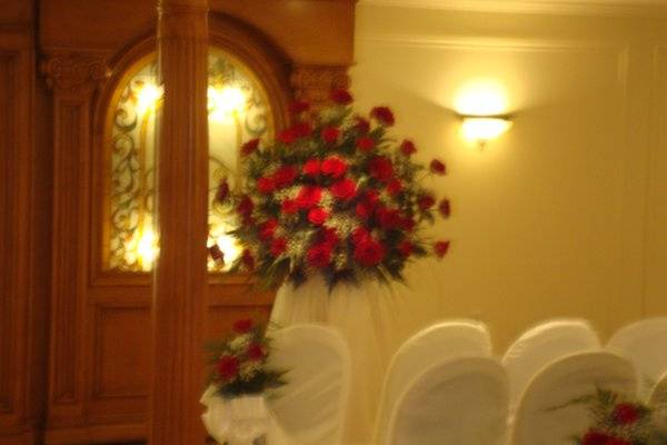 Wedding ceremony flowers designed in red roses at The Merion by Stein Your Florist Co.