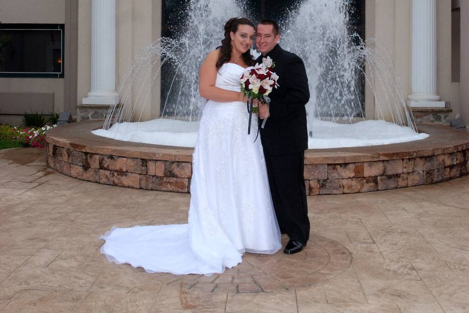 Bride and groom in front of LaBove Grande fountain.