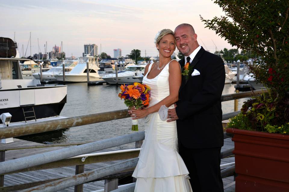 Bride and groom with Atlantic City marina in the background.